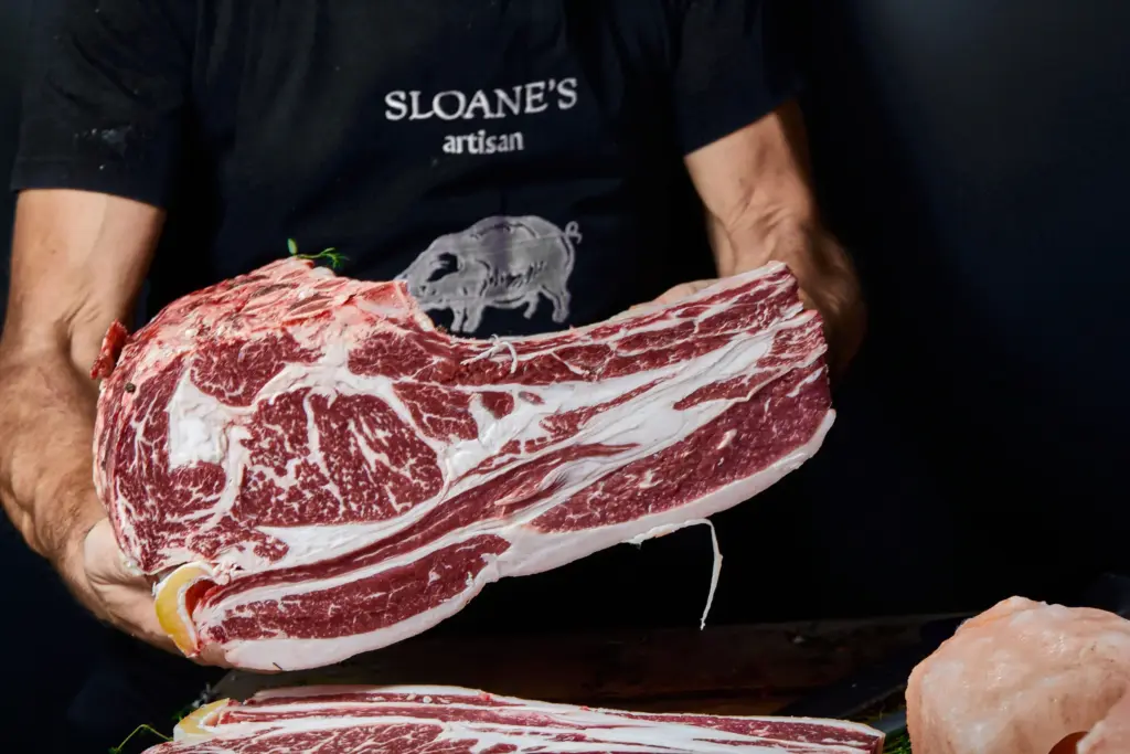 image shows sloane's butcher presenting a side of beef