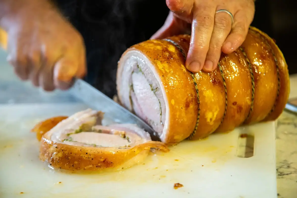 image shows a roasted porchetta
